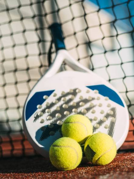 Padel blade racket resting on the net Padel blade racket